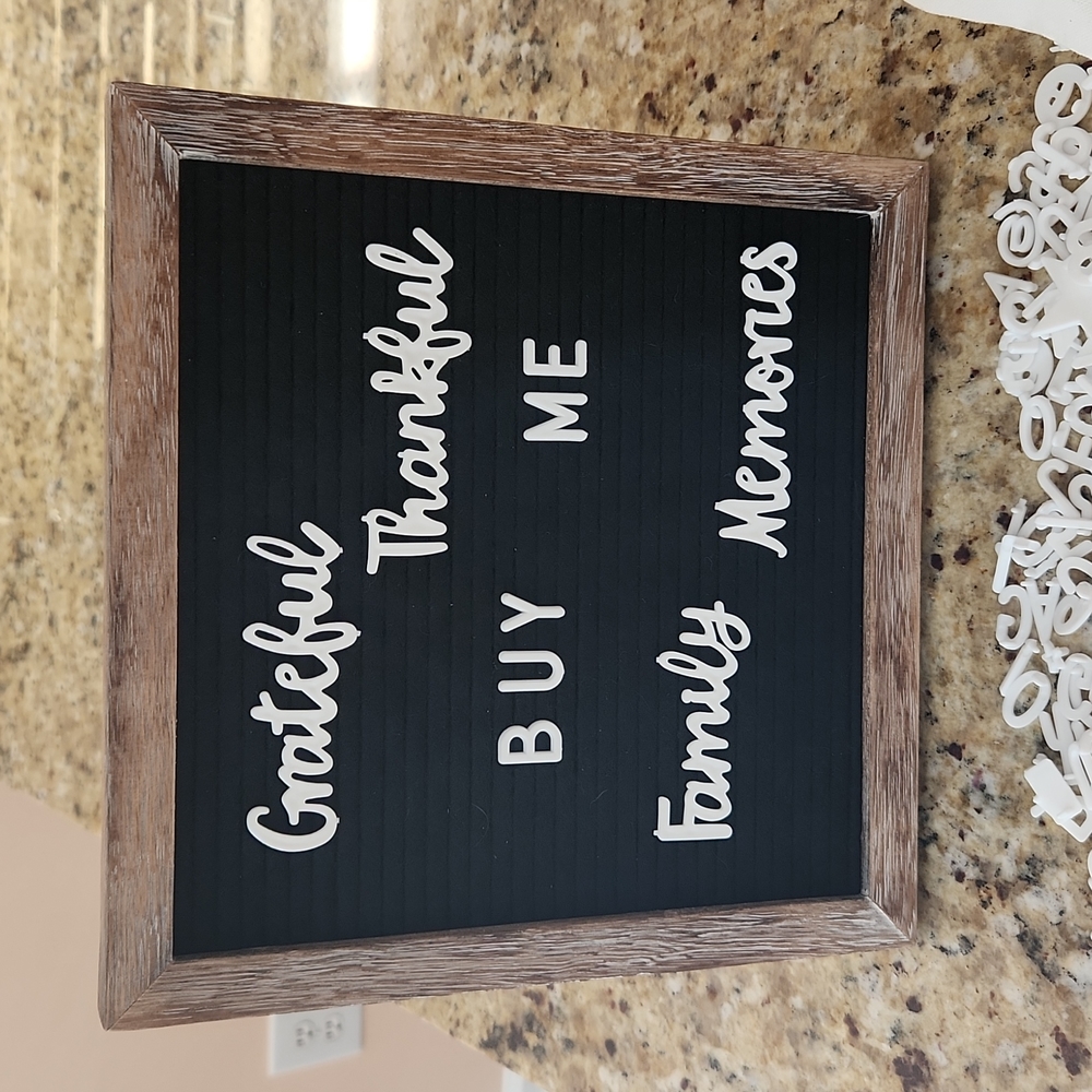 Felt canvas board/frame with a variety of letters, numbers, decorations, words.